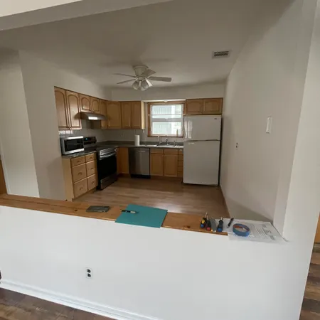 a kitchen with a sink stainless steel appliances and cabinets