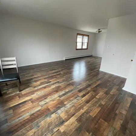 a view of wooden floor and windows in a room