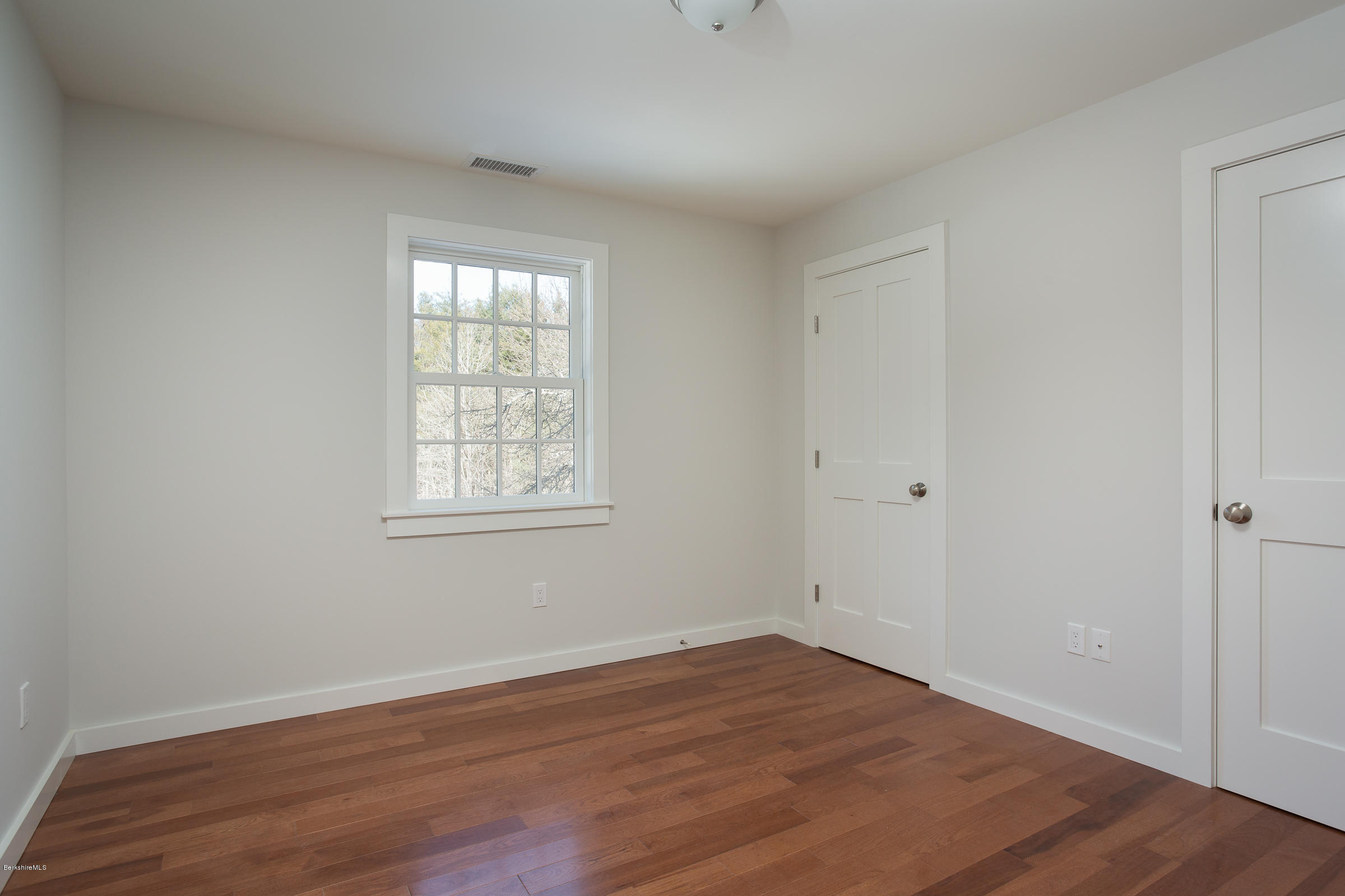 205 Main Road Monterey, MA 01245 - Photo 15 of 25 a view of an empty room with wooden floor and a window