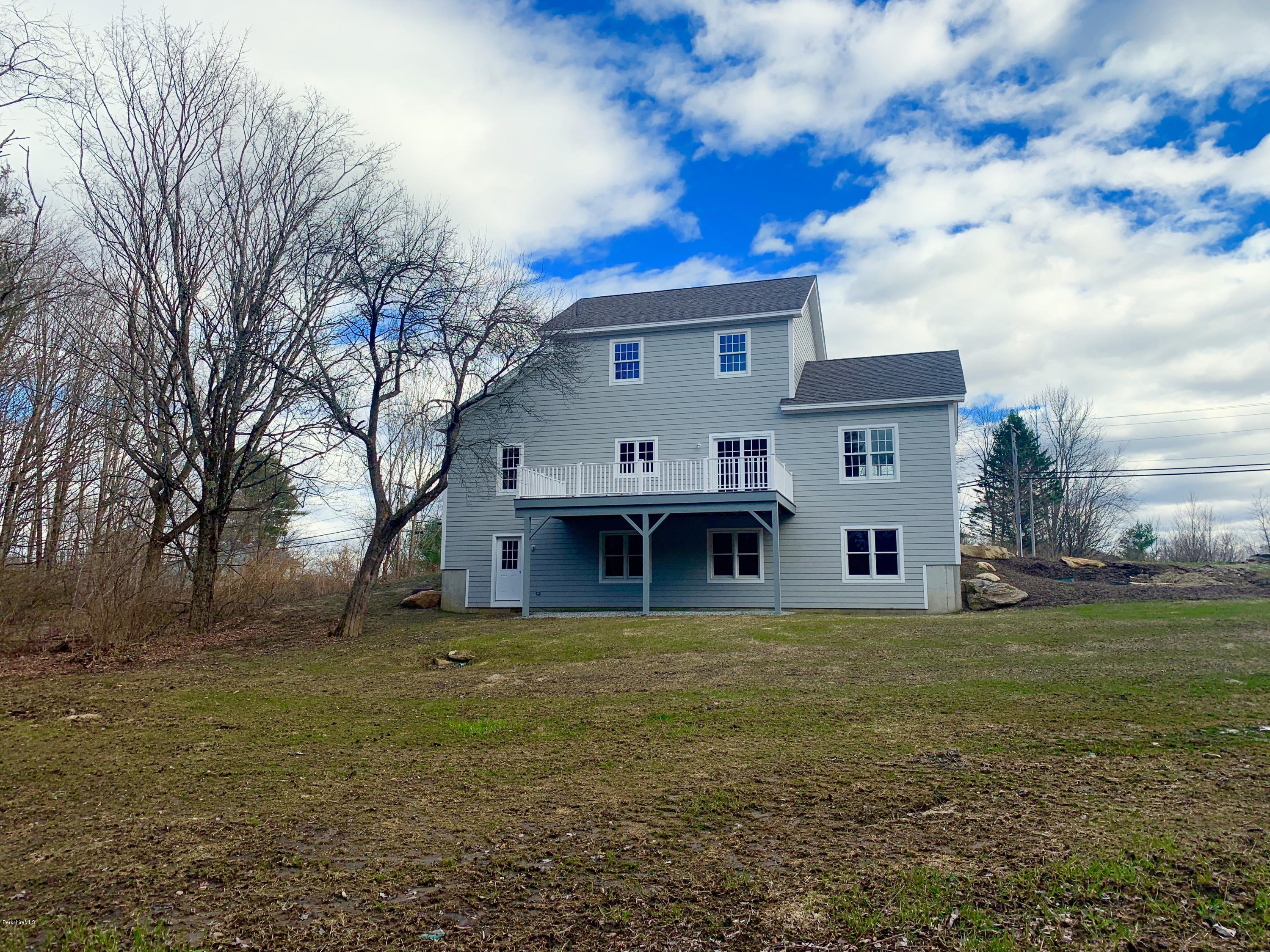 205 Main Road Monterey, MA 01245 - Photo 20 of 25 a view of a house with a large tree and a big yard