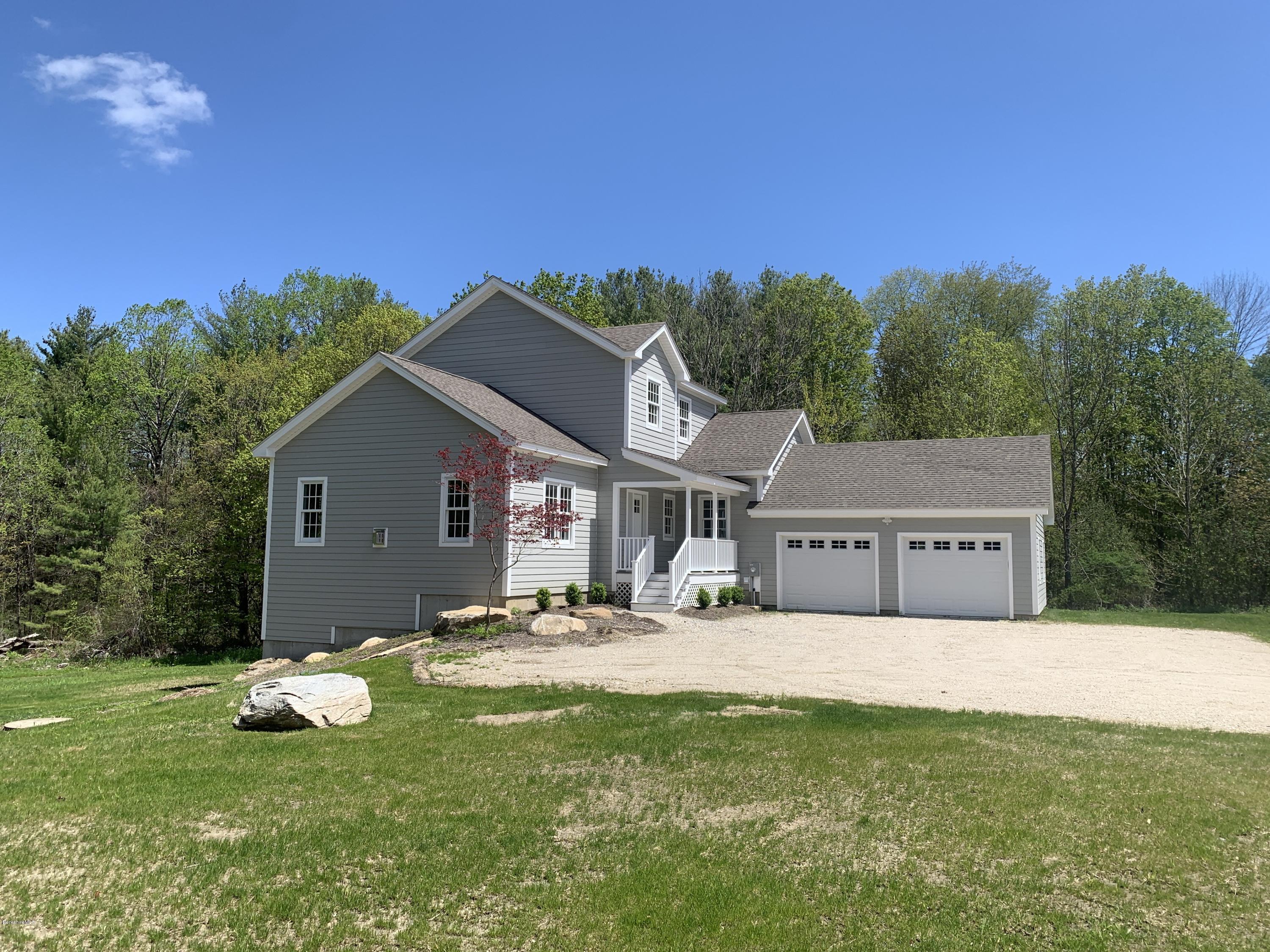 205 Main Road Monterey, MA 01245 - Photo 21 of 25 a front view of a house with a garden and yard