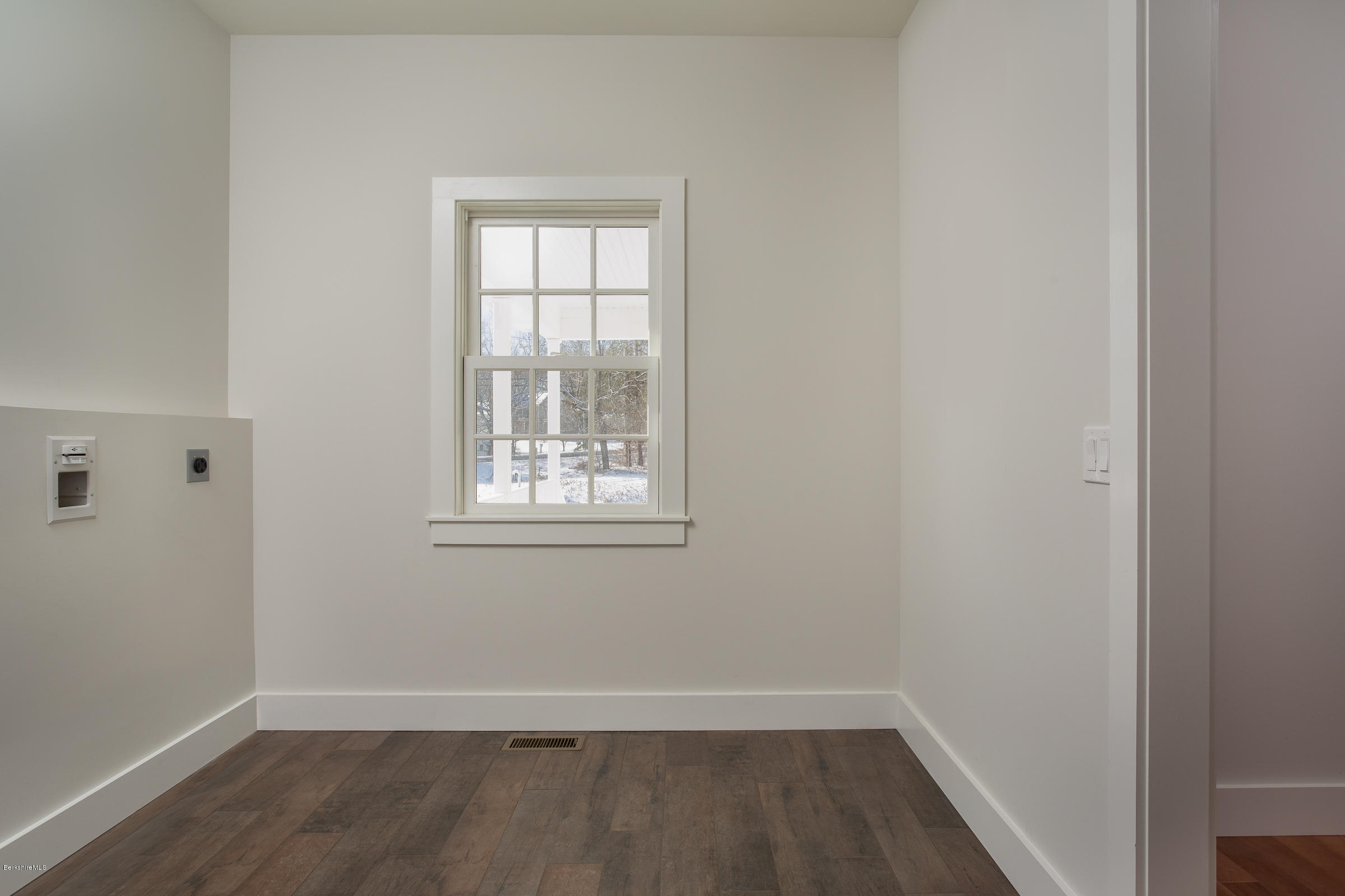 205 Main Road Monterey, MA 01245 - Photo 10 of 25 an empty room with wooden floor and windows