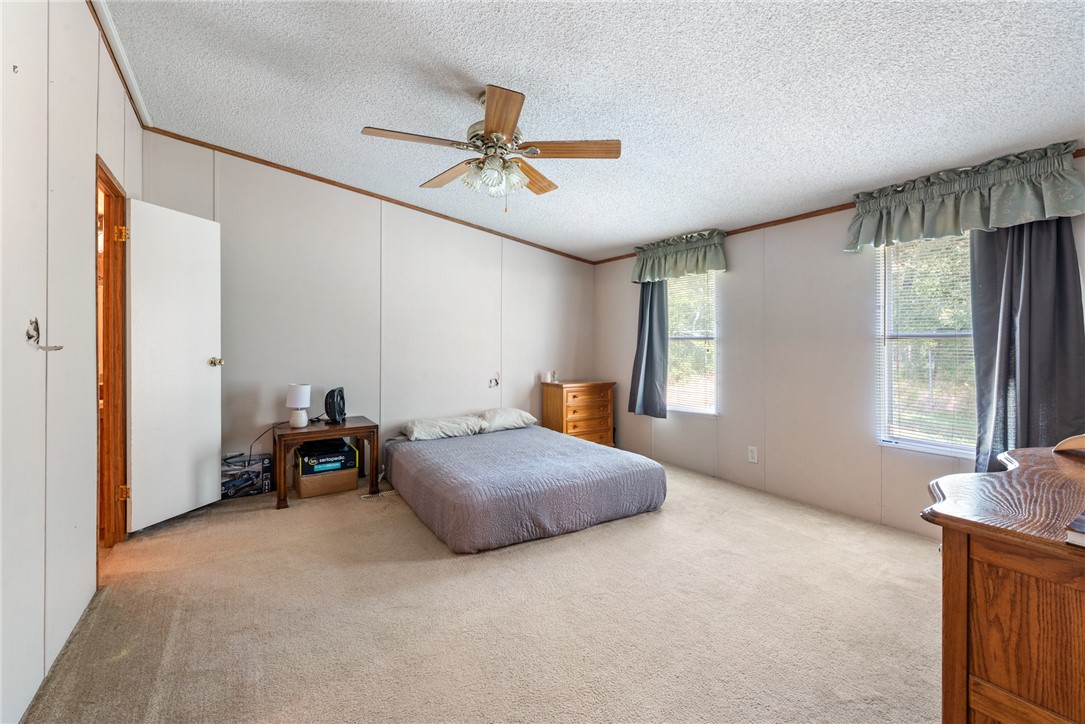 8277 Shady Lane Bryan, TX 77808 - Photo 11 of 21 a living room with a bed furniture and a window