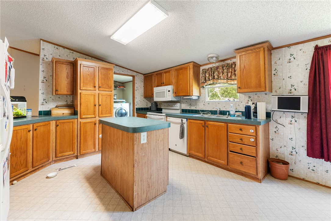 8277 Shady Lane Bryan, TX 77808 - Photo 7 of 21 a kitchen with stainless steel appliances granite countertop a stove a sink and a refrigerator
