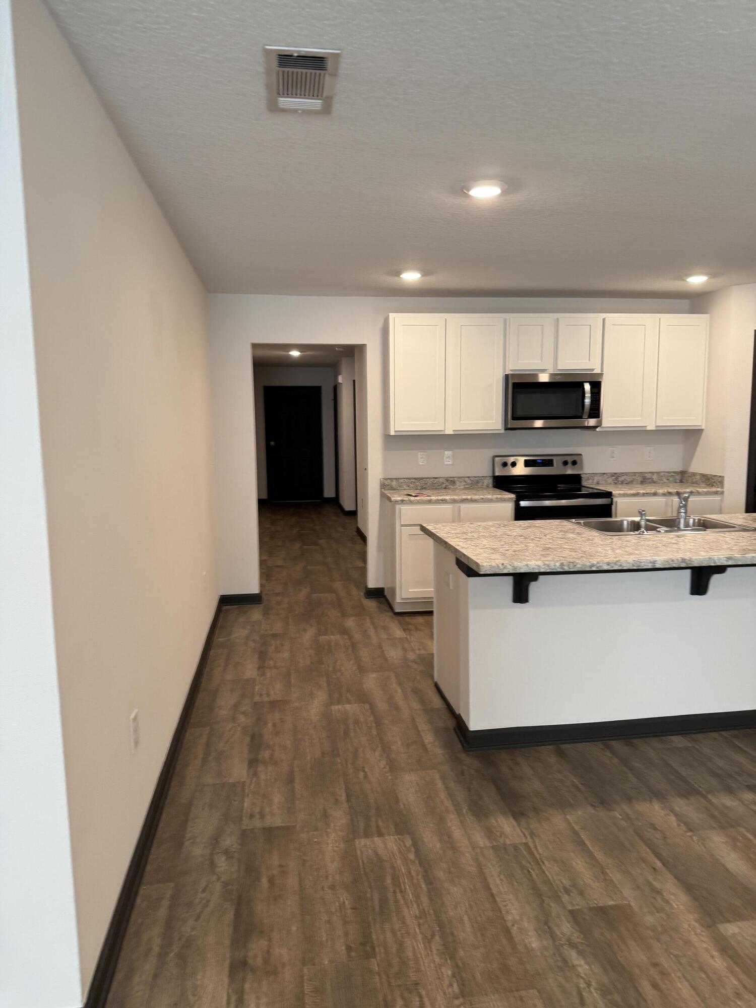 3476 Sparco Drive Crestview, FL 32539 - Photo 13 of 27 a kitchen with stainless steel appliances a stove top oven a sink and a refrigerator