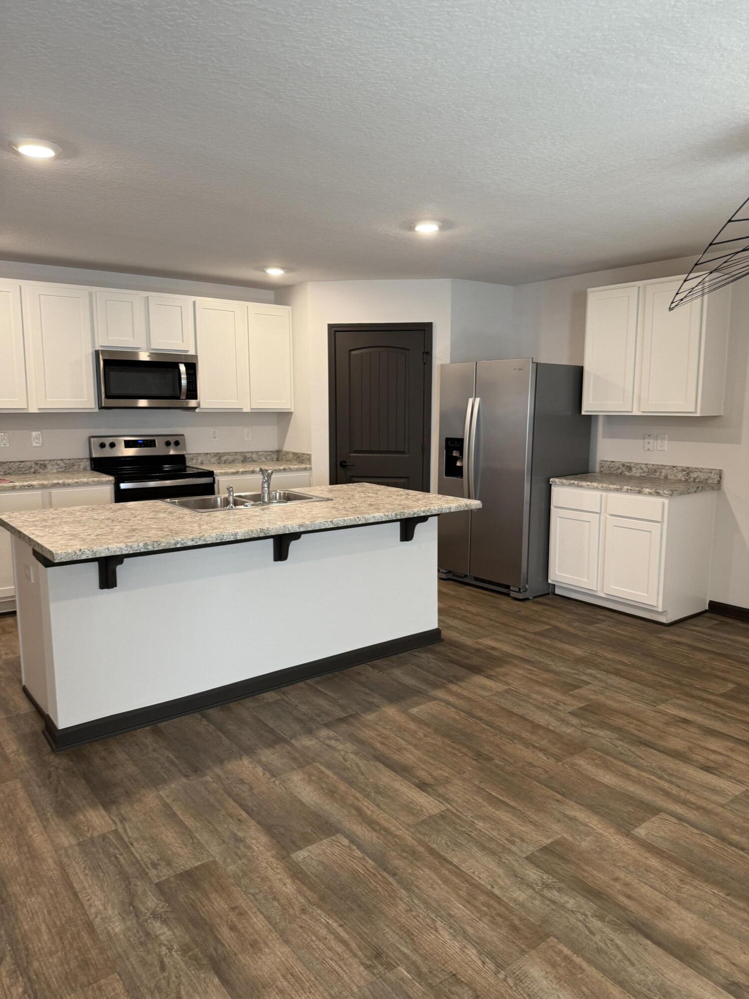 3476 Sparco Drive Crestview, FL 32539 - Photo 14 of 27 a kitchen with stainless steel appliances a refrigerator sink and microwave
