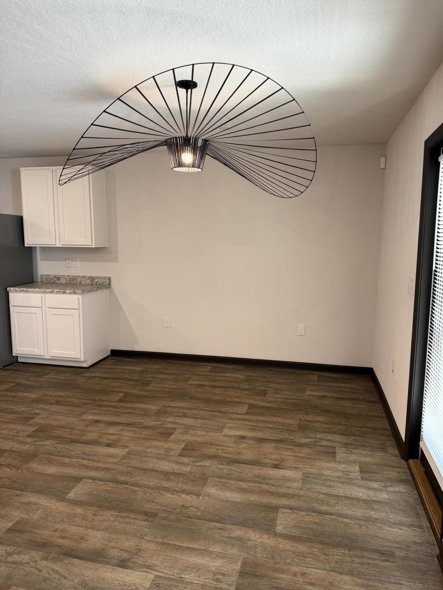 3476 Sparco Drive Crestview, FL 32539 - Photo 16 of 27 a view of kitchen and empty room with wooden floor
