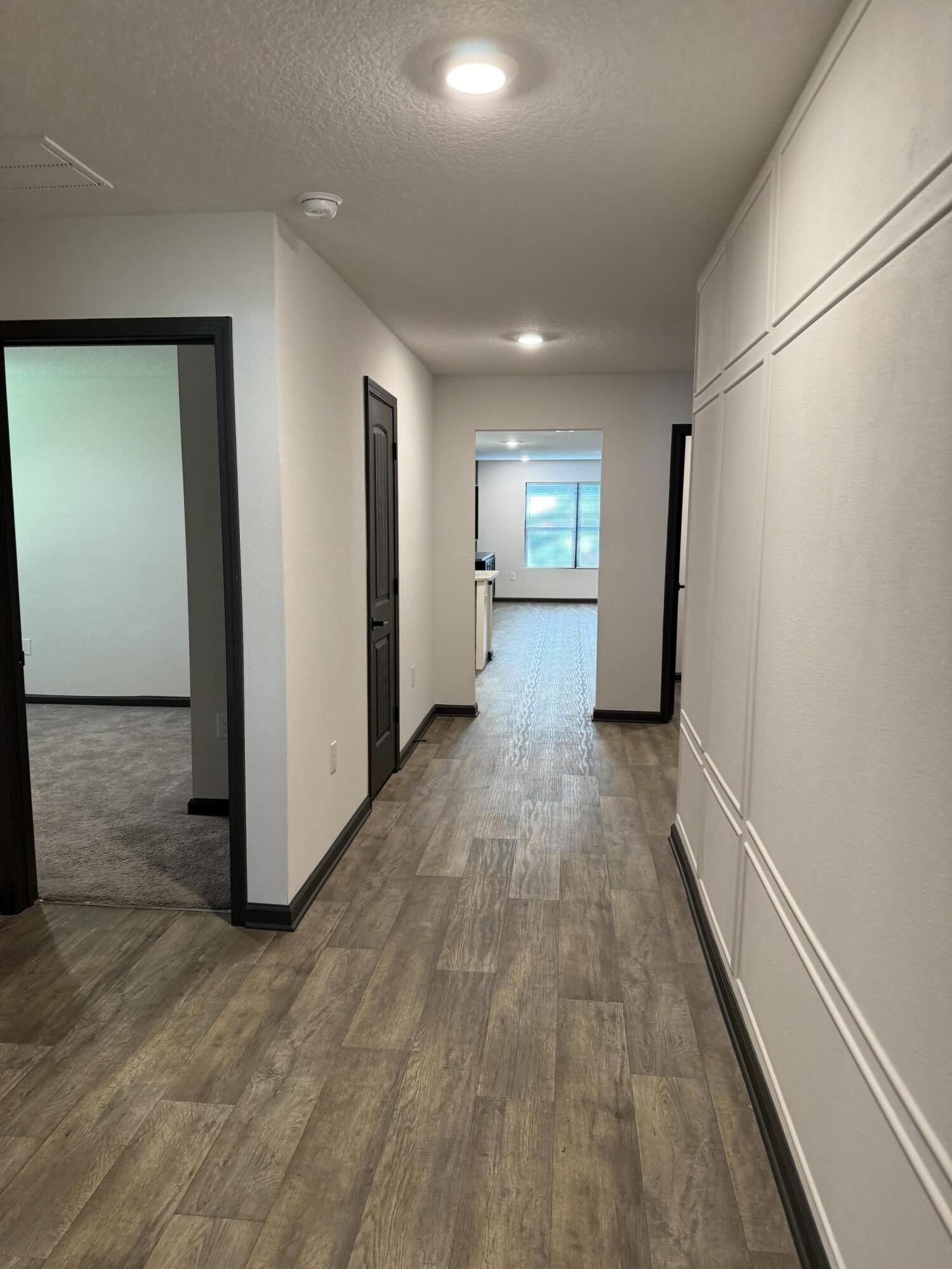 3476 Sparco Drive Crestview, FL 32539 - Photo 3 of 27 a view of a hallway with wooden floor