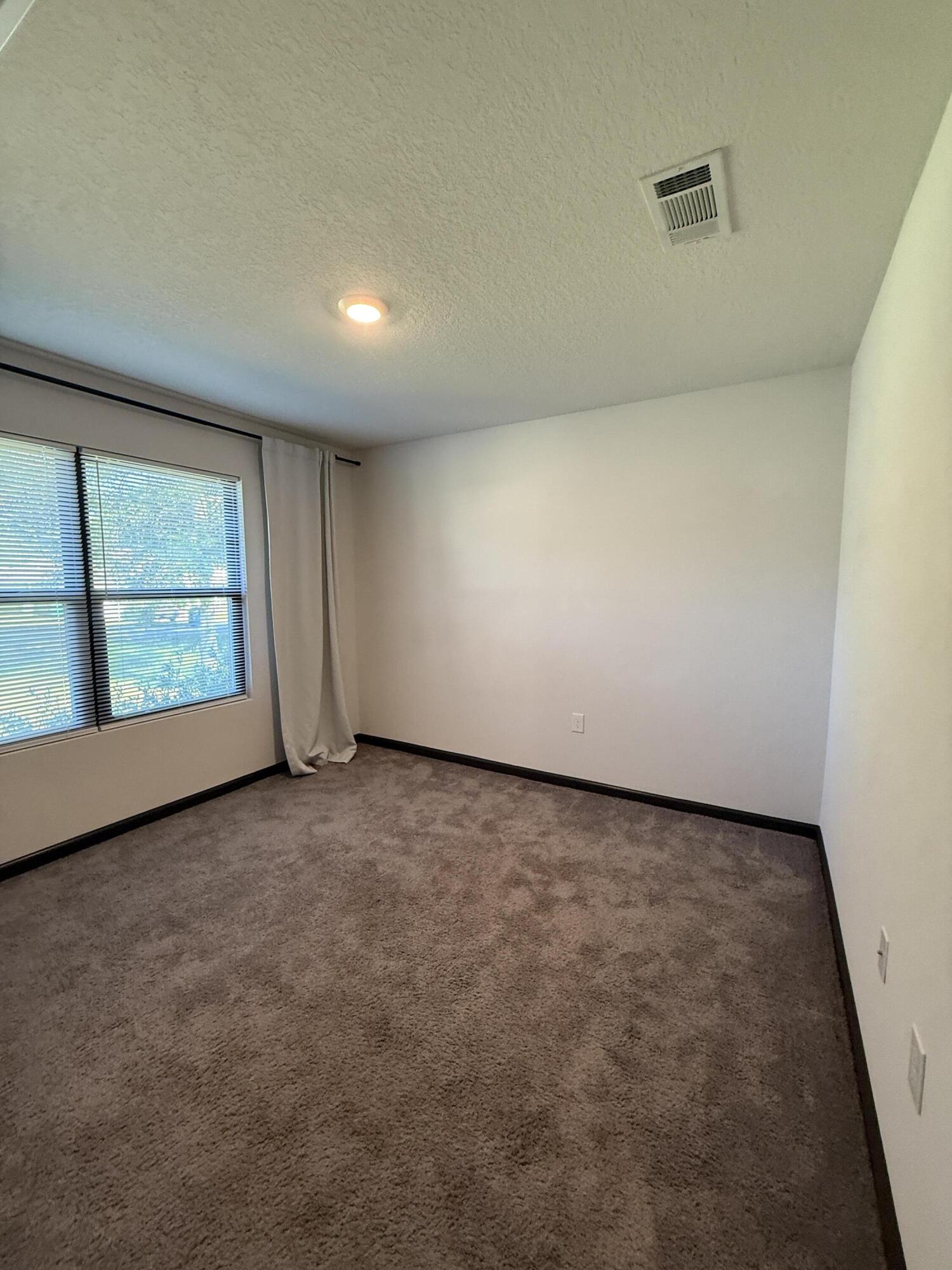 3476 Sparco Drive Crestview, FL 32539 - Photo 8 of 27 an empty room with windows