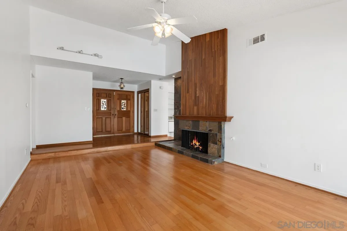 14186 Recuerdo Drive Del Mar, CA 92014 - Photo 15 of 35 a view of empty room with wooden floor and fireplace