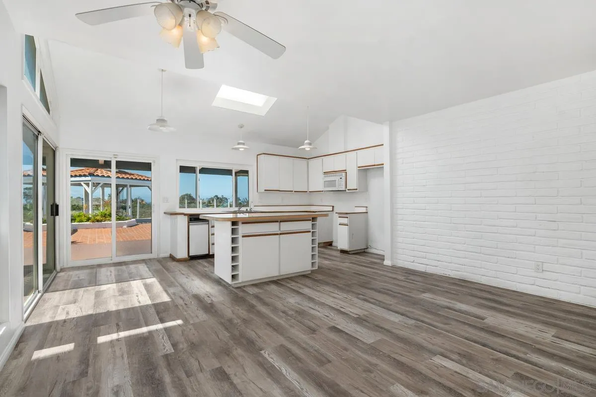 14186 Recuerdo Drive Del Mar, CA 92014 - Photo 18 of 35 a room with stainless steel appliances kitchen island granite countertop a stove a refrigerator and cabinets