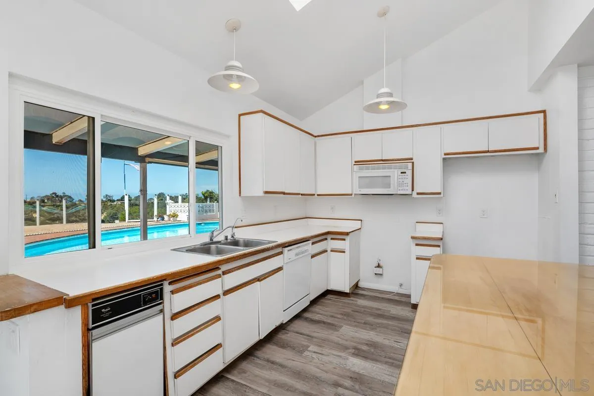 14186 Recuerdo Drive Del Mar, CA 92014 - Photo 20 of 35 a kitchen with stainless steel appliances granite countertop a stove and a sink