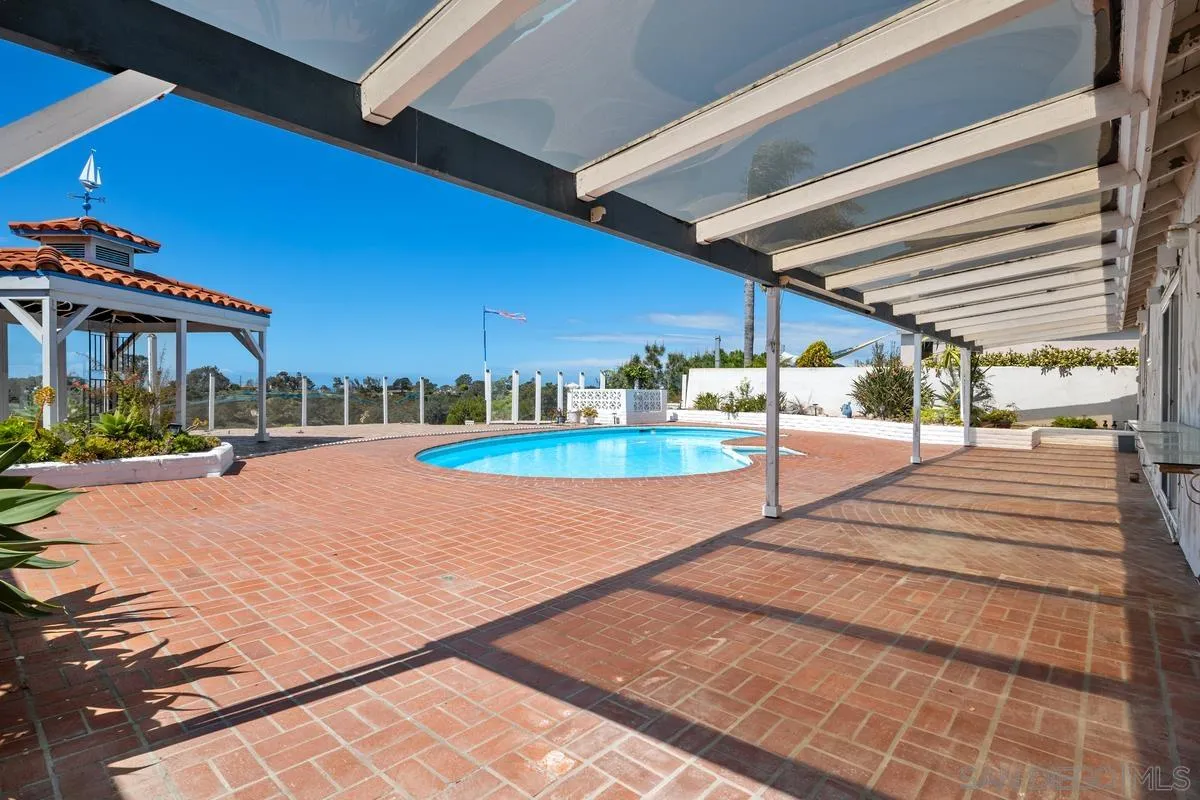 14186 Recuerdo Drive Del Mar, CA 92014 - Photo 22 of 35 a swimming pool with outdoor seating and yard