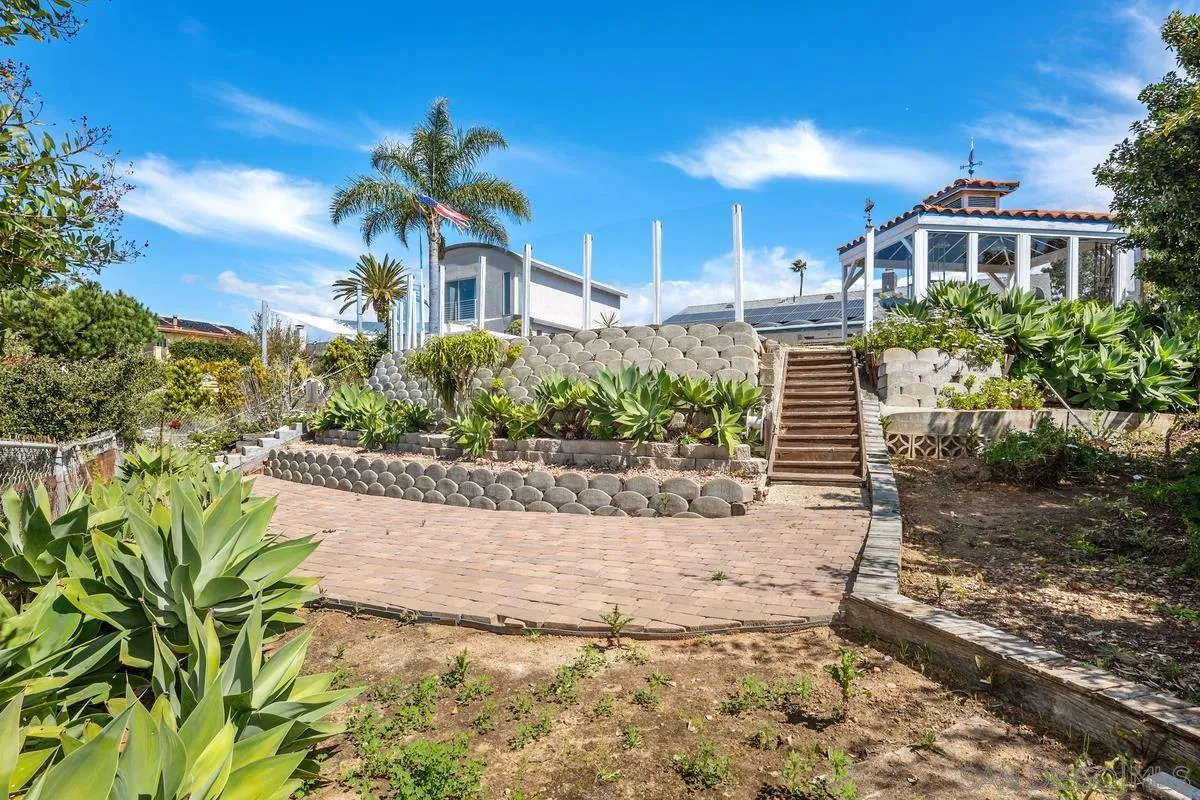 14186 Recuerdo Drive Del Mar, CA 92014 - Photo 25 of 35 a front view of a house with a yard and potted plants