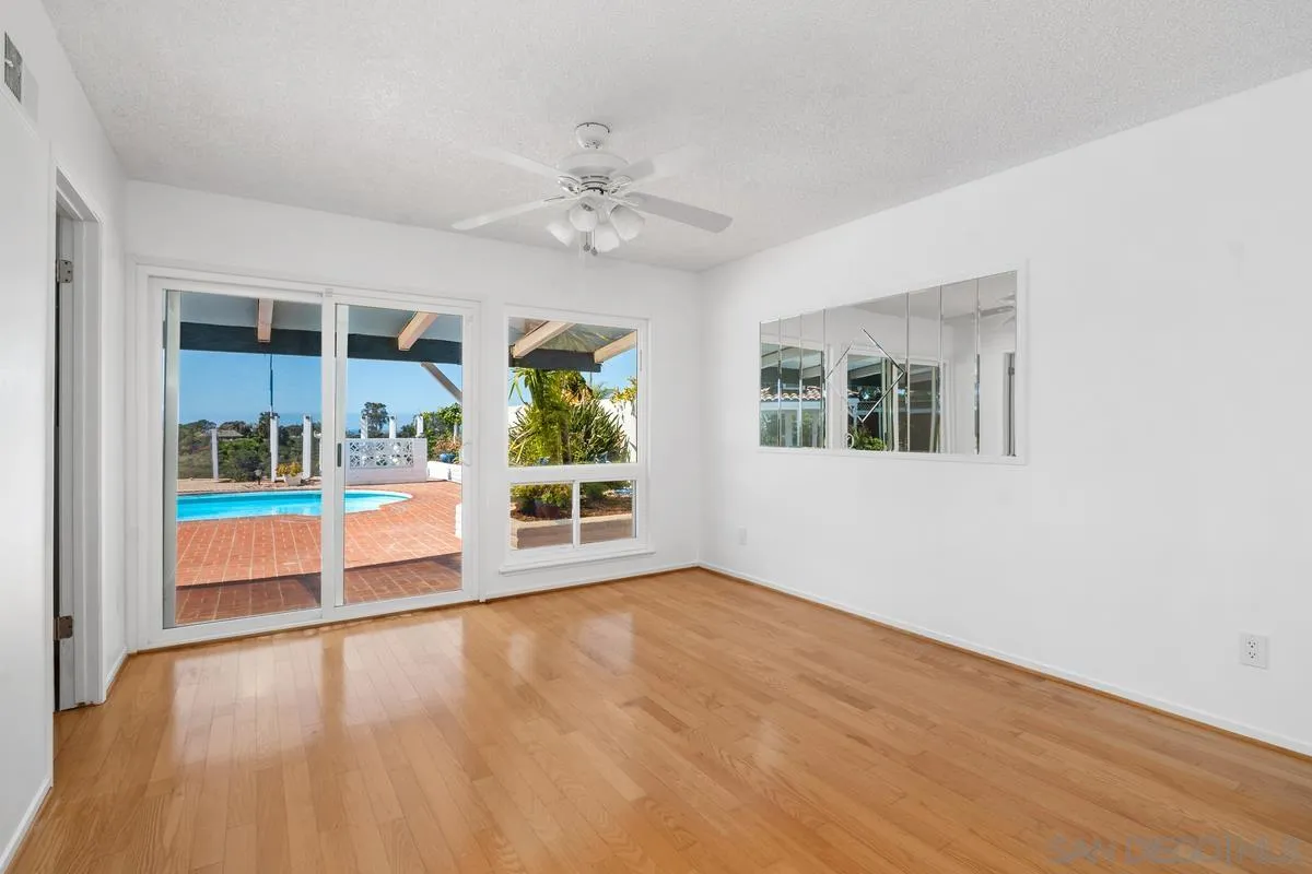 14186 Recuerdo Drive Del Mar, CA 92014 - Photo 27 of 35 a view of an empty room with a window and wooden floor