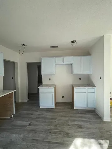 a kitchen with white cabinets and white appliances