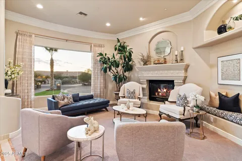 a large living room with stainless steel appliances kitchen island granite countertop a large kitchen island a stove a oven a dining table and chairs