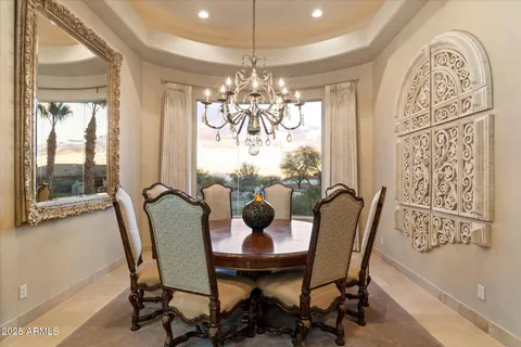 an open kitchen with granite countertop a stove and white cabinets