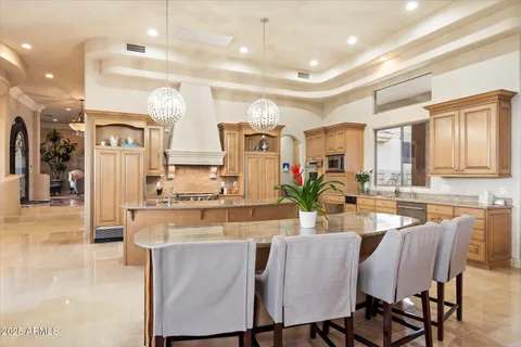 a kitchen with stainless steel appliances granite countertop a stove a sink and a refrigerator