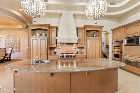 a living room with furniture a fireplace and a floor to ceiling window