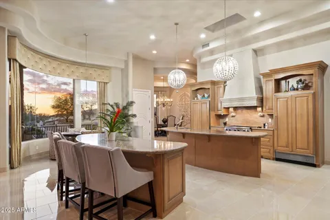 a kitchen with stainless steel appliances granite countertop a sink stove and a refrigerator