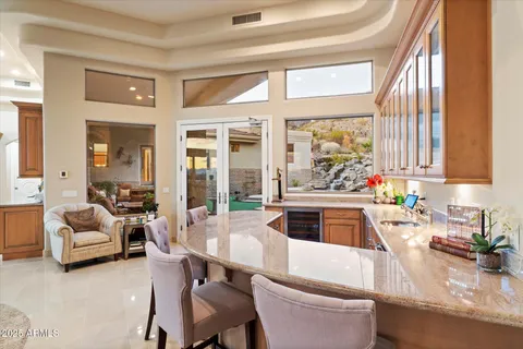 a bathroom with a granite countertop sink a mirror and shower