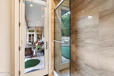 a view of a swimming pool with a patio and a garden