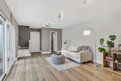 a bedroom with furniture and a wooden floor