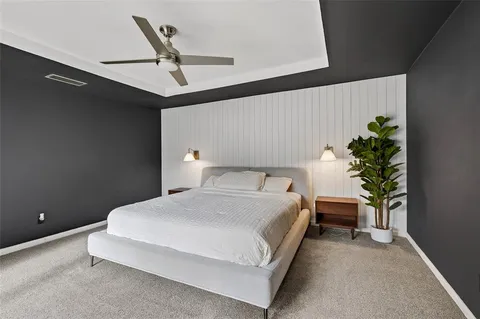 a bedroom with a bed and a potted plant