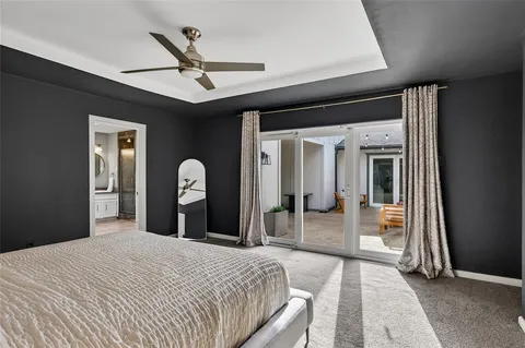 a bedroom with a bed and a large mirror