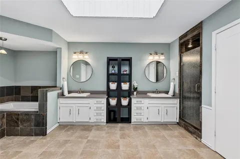 a large bathroom with double vanity and a mirror