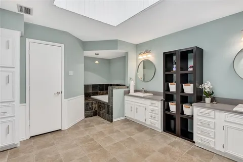 a large bathroom with a sink double vanity and a mirror