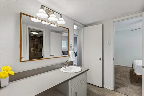 a bedroom with a large bed and a chandelier