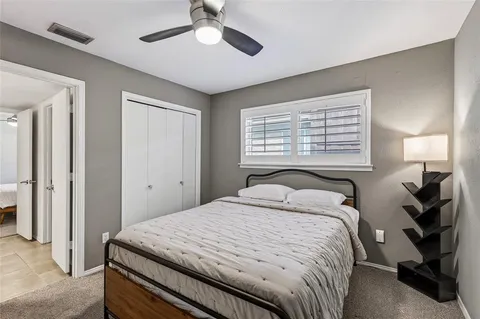 a bedroom with a bed and cabinets