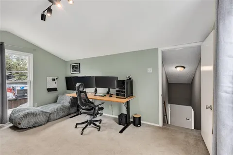 a room with gym equipment and windows