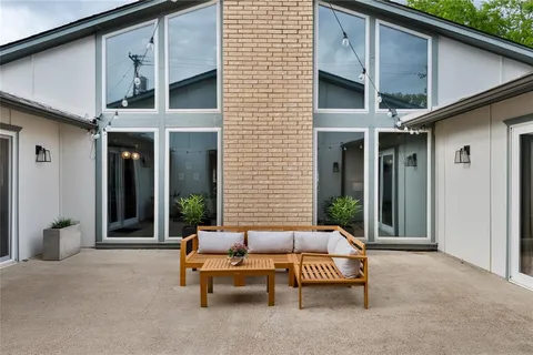 a outdoor space with patio couch and a fireplace