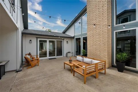 a backyard of a house with table and chairs