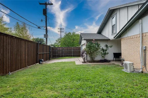 a front view of house with backyard and green space