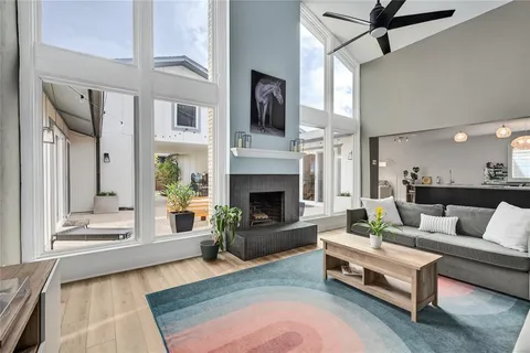 a living room with furniture fireplace and flat screen tv