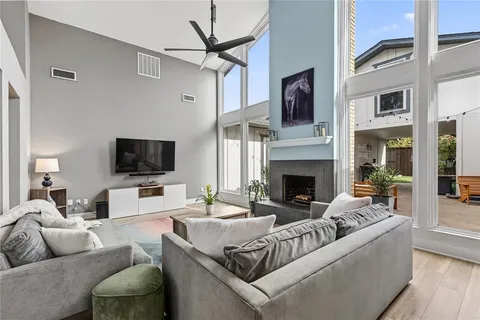 a living room with furniture a fireplace and a flat screen tv