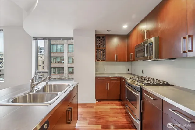 a kitchen with granite countertop a sink and a stove