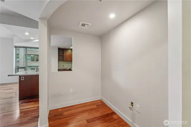 a view of a hallway with wooden floor