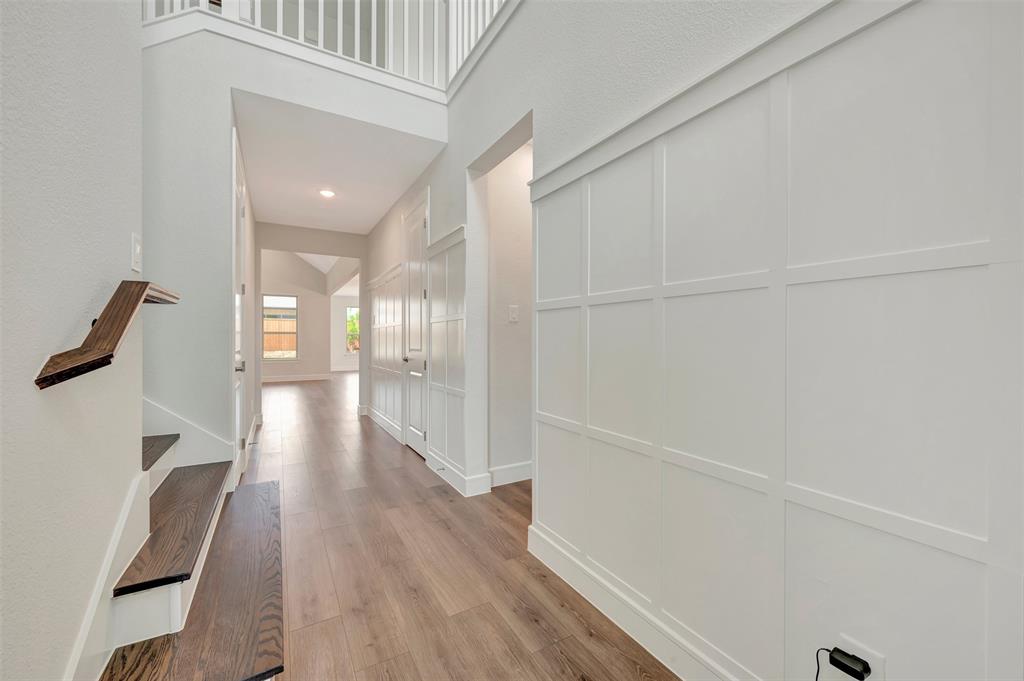 11460 Wulstone Road Fort Worth, TX 76052 - Photo 2 of 40 a view of a hallway with wooden floor