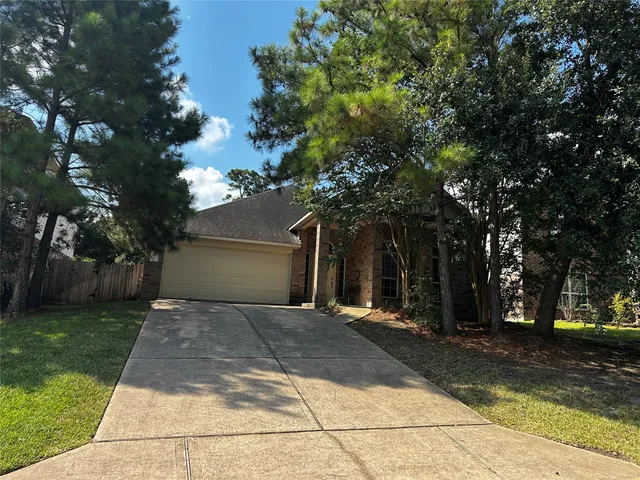 a front view of a house with a yard and a garage