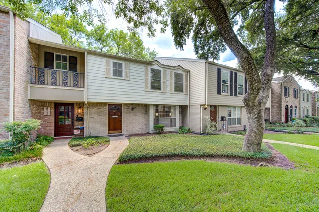 a view of a backyard with a garden and trees
