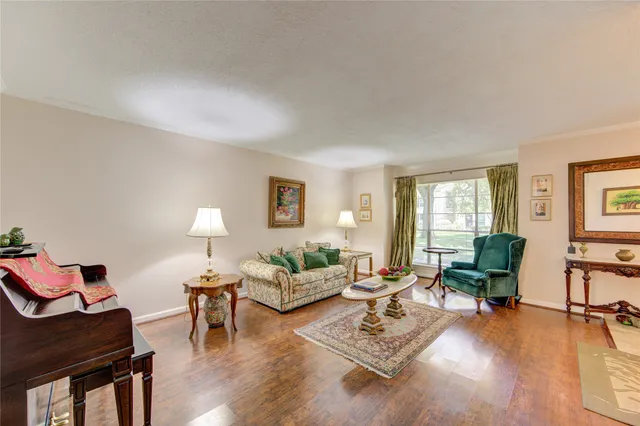 a view of a dining room with furniture wooden floor and chandelier