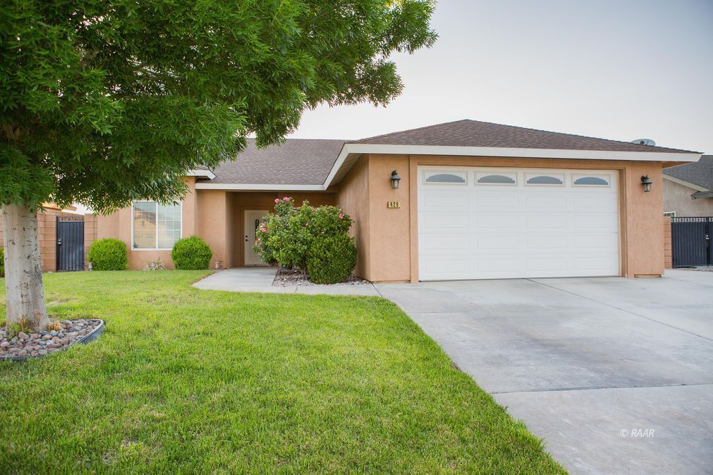 429 Acacia Street Ridgecrest, CA 93555 - Photo 1 of 1 a front view of a house with garden