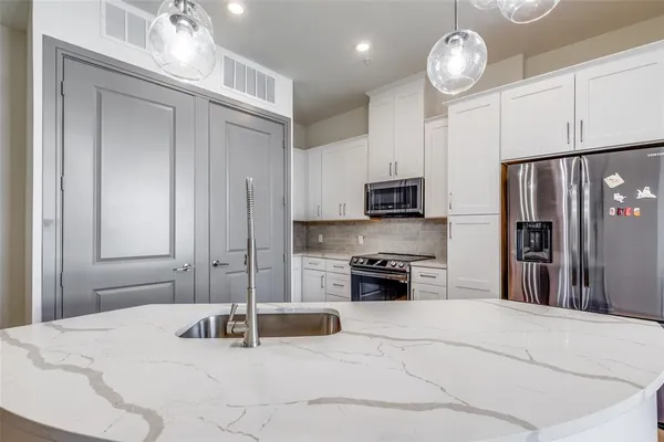 a kitchen with stainless steel appliances granite countertop a stove and a refrigerator
