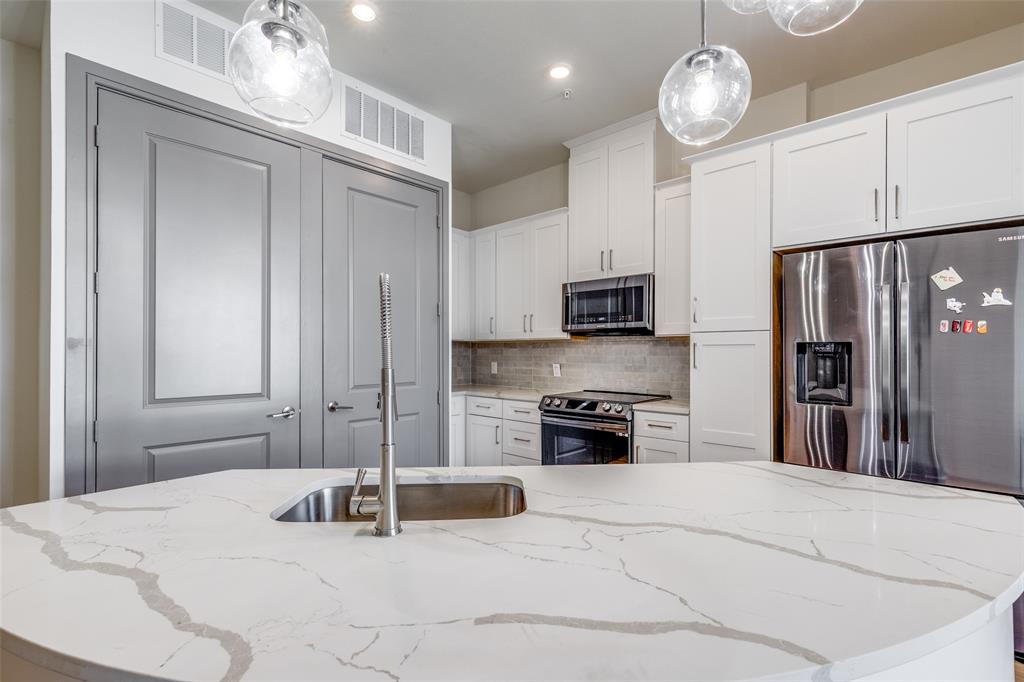 2700 Old Denton Road, Unit 3350 Carrollton, TX 75007 - Photo 3 of 12 a kitchen with stainless steel appliances granite countertop a stove and a refrigerator