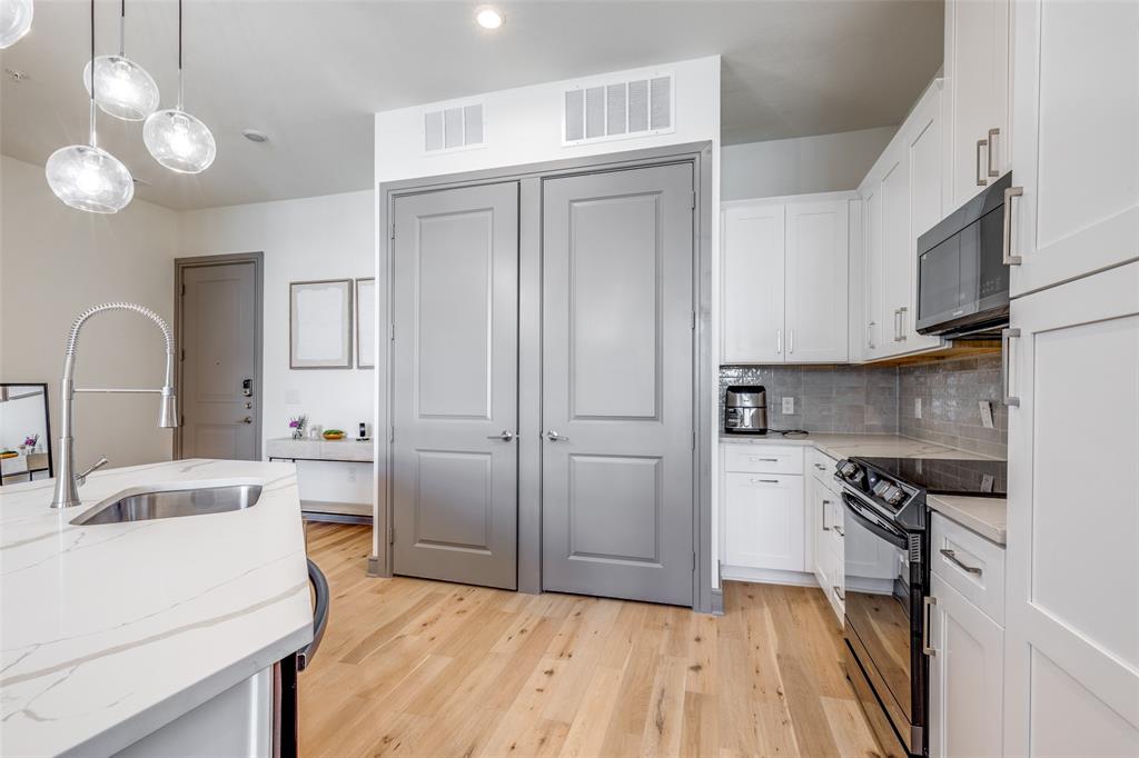 2700 Old Denton Road, Unit 3350 Carrollton, TX 75007 - Photo 4 of 12 a kitchen with a sink cabinets stainless steel appliances and a counter top space